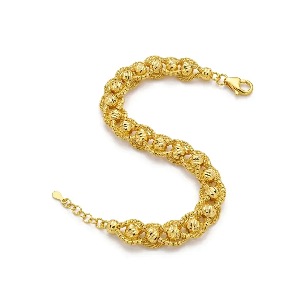 Braided Bead Bracelet in 21K gold: diamond-cut beads woven into a thick strand, laid in an S