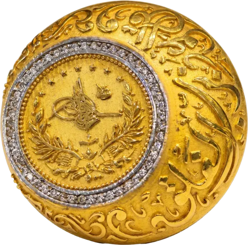 Rashadi Coin Statement Ring in 21K gold, seen from above: a coin in a stone-set halo on an engraved dome
