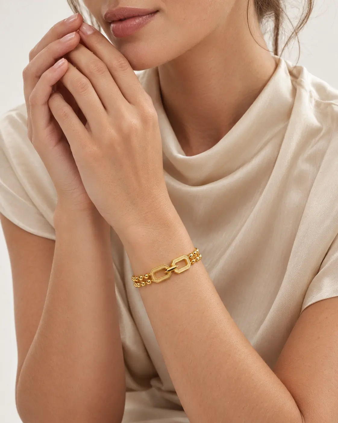 A model wearing the Dual Strand Bead Bracelet in 21K yellow gold