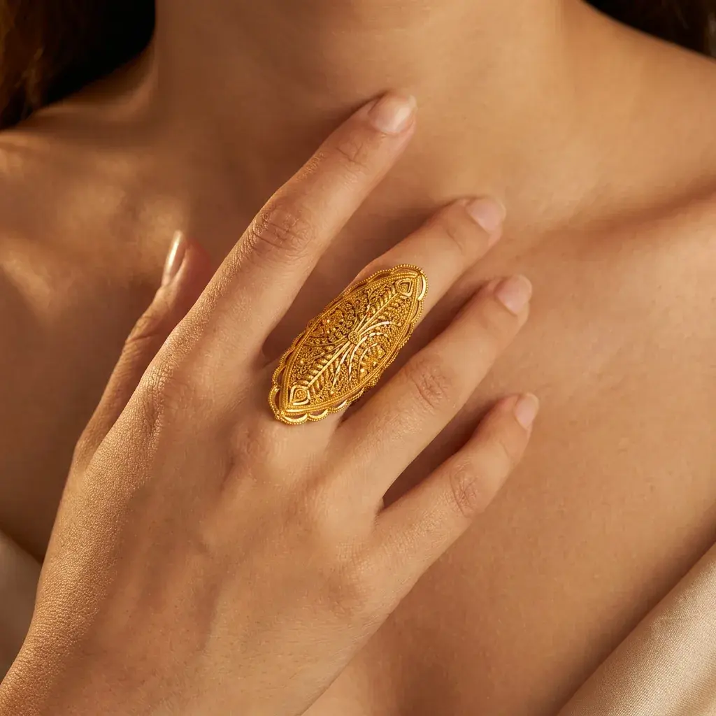 A model wearing the Marquise Filigree Ring in 21K yellow gold