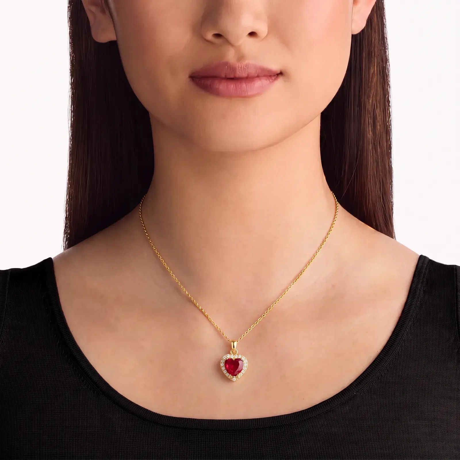 A model wearing the Heart Ruby-Tone Halo Pendant Necklace in 14K yellow gold